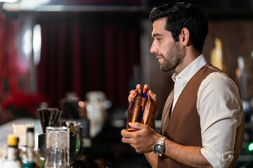 Man bartender is making a drink and dancing at bar. Dance party with group people dancing . Women and men have fun and drinking martini cocktail in night club.