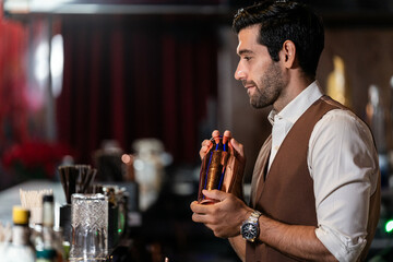 Man bartender is making a drink and dancing at bar. Dance party with group people dancing . Women and men have fun and drinking martini cocktail in night club.