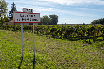 City road sign Lalande de Pomerol near Saint-Emilion wine making region, growing of Merlot or Cabernet Sauvignon red wine grapes, France, Bordeaux