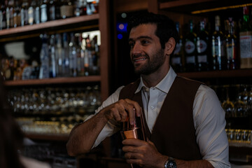 Man bartender is making a drink and dancing at bar. Dance party with group people dancing . Women and men have fun and drinking martini cocktail in night club.