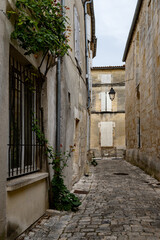 View on old streets and houses in Cognac white wine region, Charente, walking in town Cognac with...
