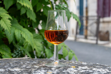 Tasting of cognac alcohol drink and view on old streets and houses in town Cognac, Grand Champagne,...