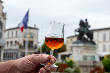 Tasting of cognac alcohol drink and view on old streets and houses in town Cognac, Grand Champagne,...