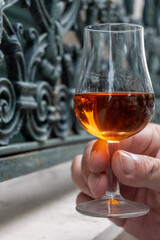 Tasting of cognac alcohol drink and view on old streets and houses in town Cognac, Grand Champagne, Charente, strong spirits distillation industry, France