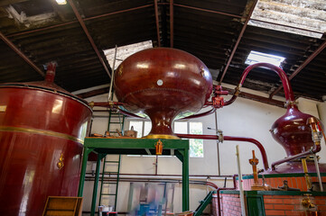 Double distillation process of cognac spirit in Charentias copper still pots and boilers in...