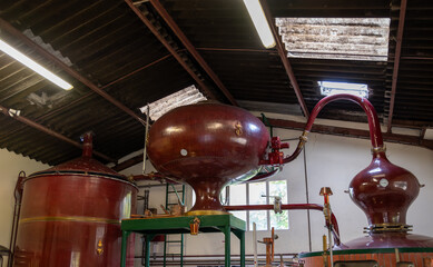 Double distillation process of cognac spirit in Charentias copper still pots and boilers in...