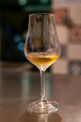 Tasting of cognac spirit aged in old French oak barrels in cellar in distillery in Cognac white wine region, Charente, Segonzac, Grand Champagne, France