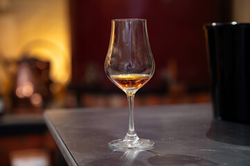 Tasting of cognac spirit aged in old French oak barrels in cellar in distillery in Cognac white wine region, Charente, Segonzac, Grand Champagne, France