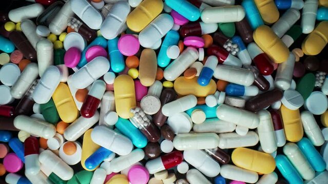 Colorful drugs, antibiotic capsules. Cure flu medication. Macro view of tablets. Pharmacy, medicine concept. Pain killer bio medicine