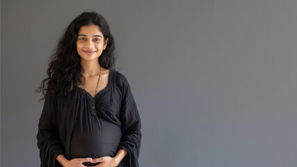 Indian pregnant woman with pregnancy belly, in soft black clothes - obrazy, fototapety, plakaty