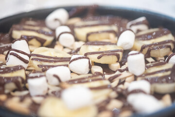 Slice of banana and marshmallow with chocolate. Close up