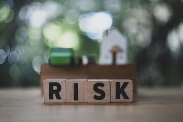 Risk factors. Risky business environment with home, car and money. The concept of reducing possible...