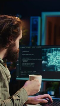 Vertical video Programmer being asked existential questions by awaken AI gaining consciousness, emulating humans and passing turing test. Man communicating with artificial intelligence, camera B