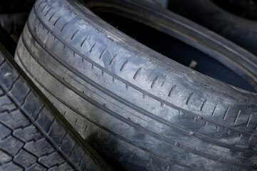 Wear and tear of old rubber car tires. Worn out treads of old rubber vehicle tire. Damaged rubbers...