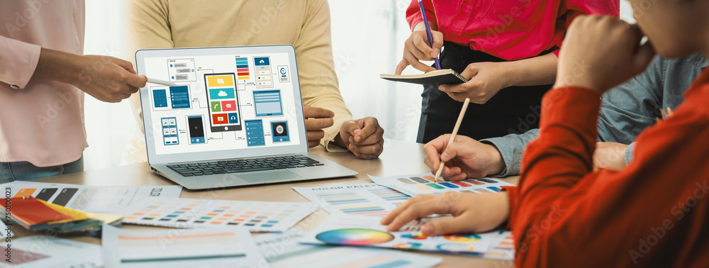 Poster cropped image of interior designer team presents color by using color swatches while laptop displaye