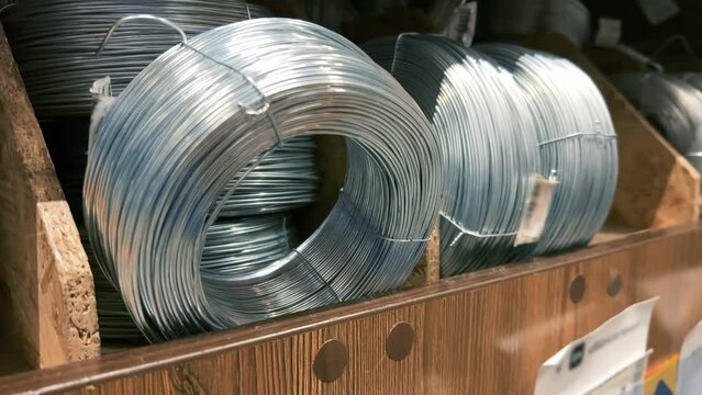 Coils of wire without braiding in a hardware store on a shelf. Close-up