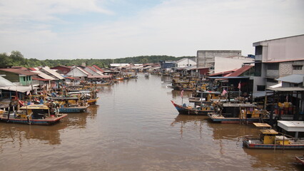 A fishing village with boats parked along the river delta