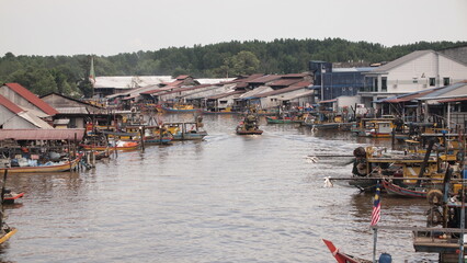 A fisherman boat leaving the fishing village in the river