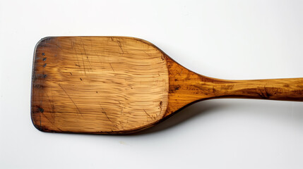 Worn wooden cooking spatula on white.