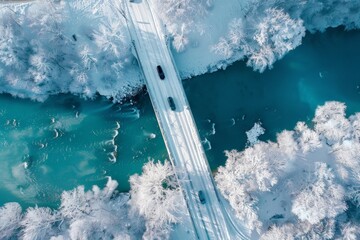 Aerial top view of snow winter road with cars over blue river