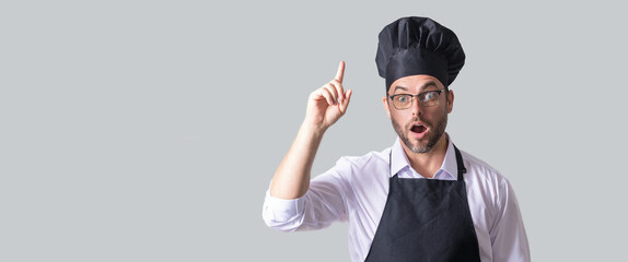 Handsome male chef cook or baker man in apron, shirt and cooking hat isolated on gray background....
