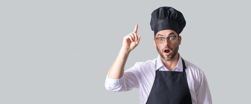 Handsome male chef cook or baker man in apron, shirt and cooking hat isolated on gray background. Cooking food concept. Mock up copy space. Chef Man in chef hat. Isolated banner of man cooking.