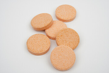 Chewable vitamin c tablet as a body supplement concept background