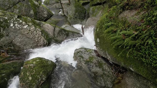 Verdant riverside waterfall in Barrias, Felgueiras Portugal - aerial