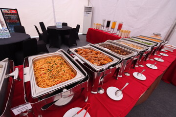 various food in a buffet roll top chafer