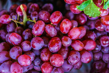 Plenty of red wine grapes healthy fruits In the fresh market in Thailand