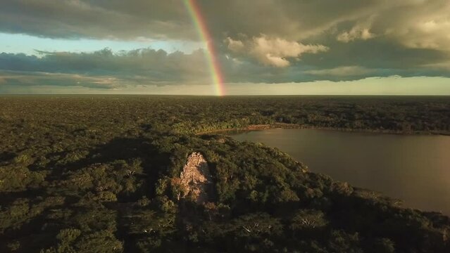 Aerial view of Mayan Pyramid with a clear rainbow and a lake in the middle of the jungle in the Mayan Ruins of Coba in Tulum, Riviera Maya, Mexico