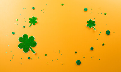 Happy St Patrick's Day decoration concept made from shamrocks ( clover leaf) on yellow background.