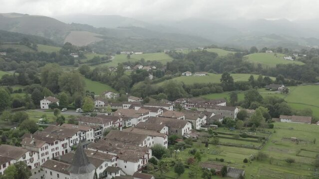 Ainhoa village in Pyrenees Atlantiques, Nouvelle Aquitaine in France. Aerial forward on cloudy day