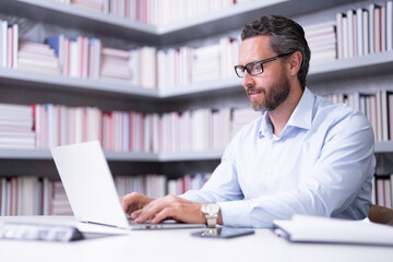 Portrait of teacher with book in library classroom. Handsome teacher in university. Teachers Day. Good school teacher. Tutor at college. Man with books in library. Knowledge and education concept.