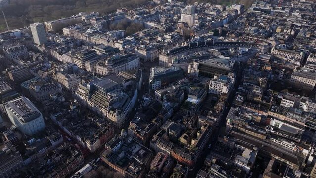 Dolly back pan up aerial shot over central London Soho and Belgravia