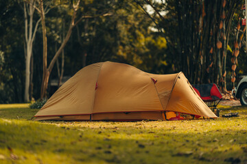 A tent on the grass with a view of the mountains in the background and sunlight. Holiday, Travel, Long weekend, Vacation and camp concept.