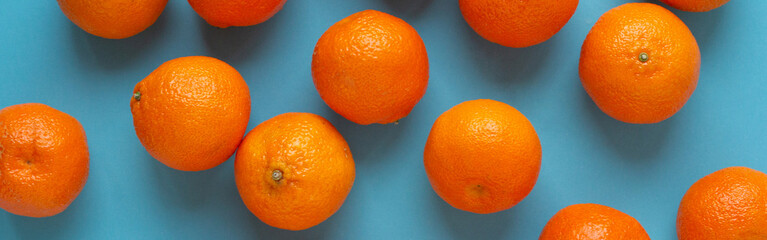 Fresh orange fruits banner with light blue background. Vibrant photo of citrus food top view. Vitamin C