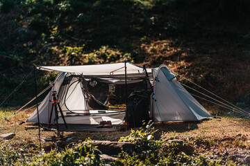 camping lantern Hanging on poles and tents pitched on hillsides beside streams of water from...