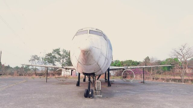 Abandoned airplane on a deserted airfield at dusk with faded paint and clear sky