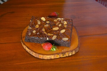 Fudgy brownies with almond slices on top. Cake on the table