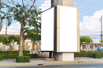 Vertical billboard for displaying commercials in street. Cars and public transport passing by....