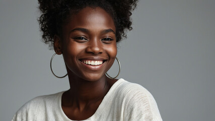 Beauty portrait of african american woman with clean healthy skin on beige background. Smiling beautiful afro girl. Curly black hair - obrazy, fototapety, plakaty