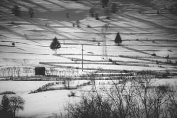 Mountain snowy forest landscape with small cottages covered in snow