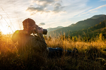 Professional nature photographer in mountain with sunset - 750360607