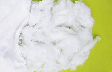 White pillow with polyester stable fiber on green background.