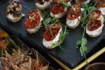 Mini snacks with various vegetables and herbs are on the table