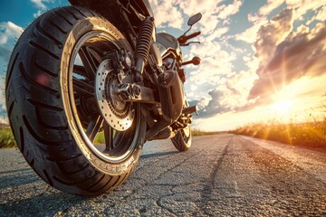 motorcycle on asphalt road in summer, A motorcycle is parked on a road with trees in the background
