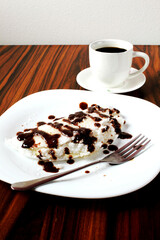 Brazilian dessert. Sweet tapioca, tapioca stuffed with coconut grated and chocolate syrup topping with coffee cup.