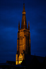 Bruges in Belgium. Church tower at night.