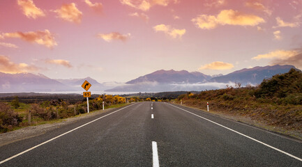 The Road trip view of  travel with mountain view of autumn scene and  foggy in the morning with sunrise sky scene at fiordland national park